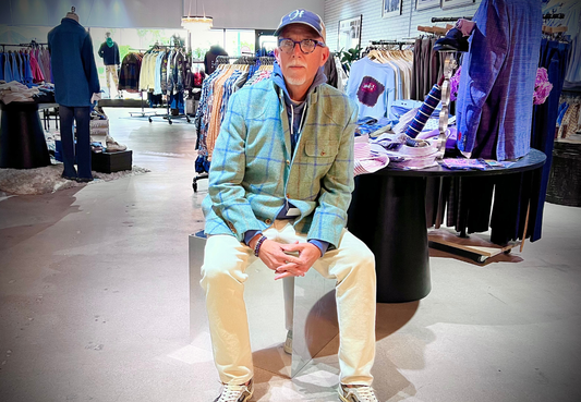 Image of me sitting in the middle of the store wearing Alexander Julien Trailblazer coat